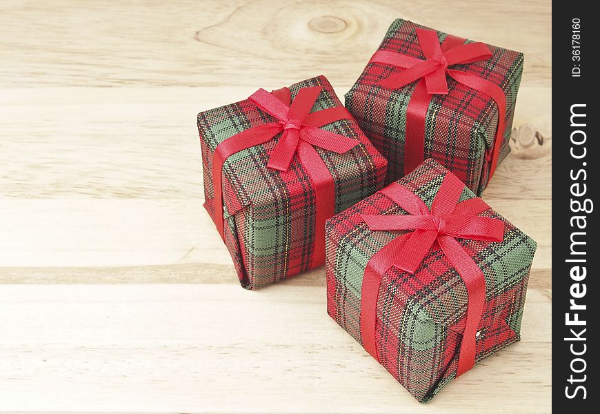 Three of red gift box decorate on wood background. Three of red gift box decorate on wood background