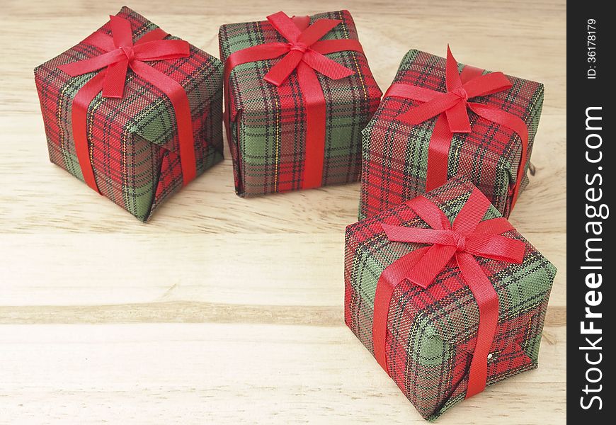 Four of red gift box decorate on wood background. Four of red gift box decorate on wood background