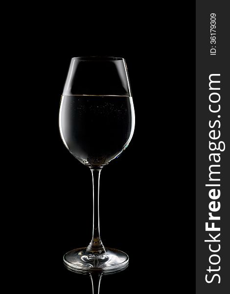 Silhouette of a wine glass with liquid. Isolate on black. Silhouette of a wine glass with liquid. Isolate on black.