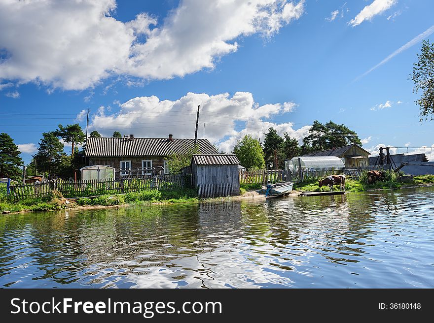 Russian wooden houses at river bank