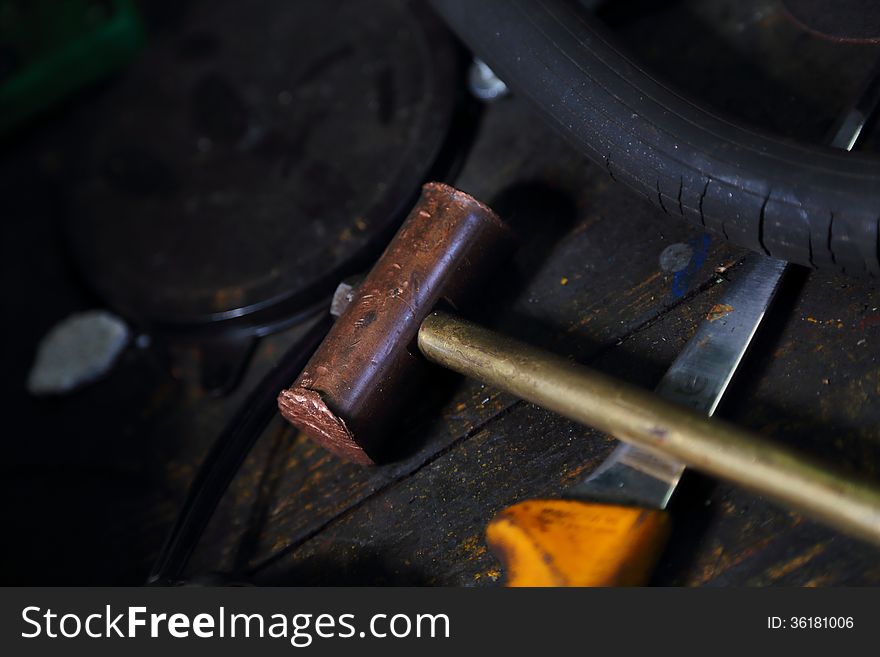 Old hammer and yellow knife on workbench. Old hammer and yellow knife on workbench