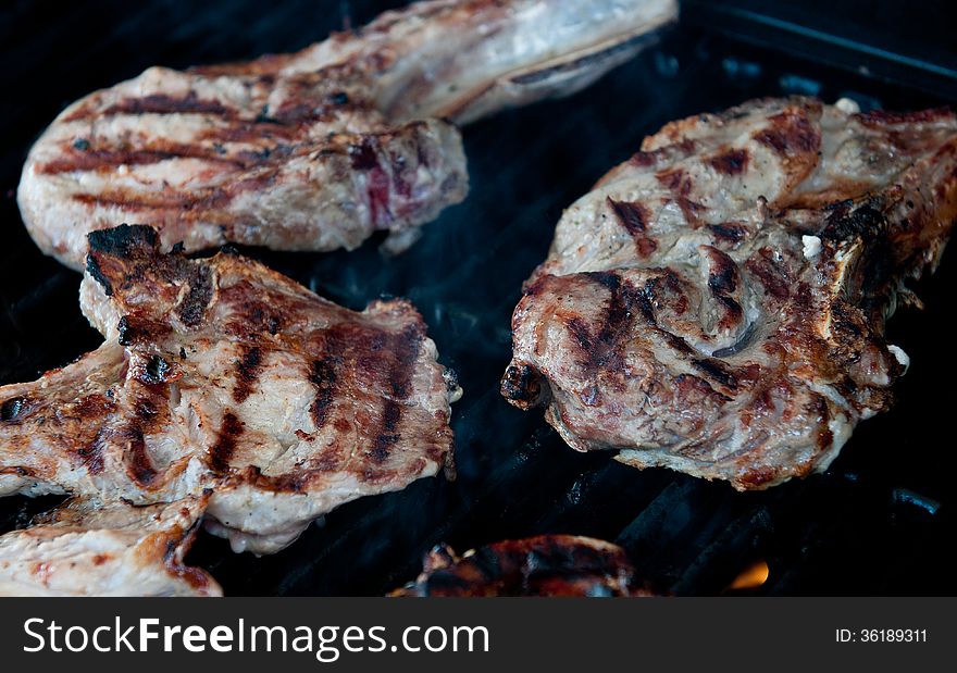 Raw pork steaks meat cooked on grill. Raw pork steaks meat cooked on grill