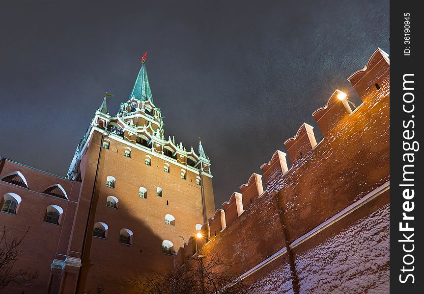 Night snowstorm in Moscow. Trinity Tower - the tallest of the 20 towers that surround the Moscow Kremlin. Russia.