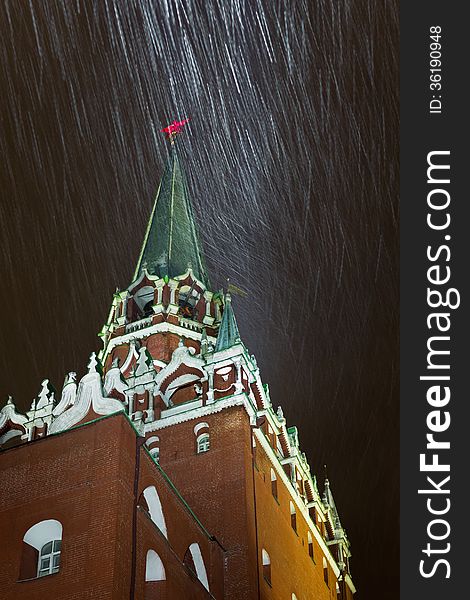 Night snowstorm in Moscow. Trinity Tower - the tallest of the 20 towers that surround the Moscow Kremlin. Russia.