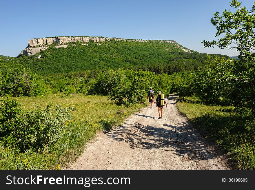 Man and women walking at the road. Crimea, Ukraine. Man and women walking at the road. Crimea, Ukraine.