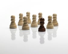 Chess Pawns / Standing Out Of The Crowd Stock Images