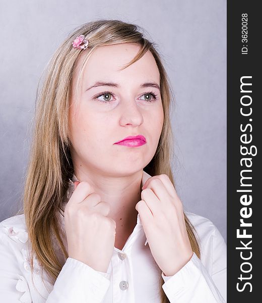 Confident blonde young woman in the wihite shirt