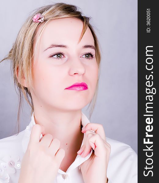 Confident blonde young woman in the wihite shirt