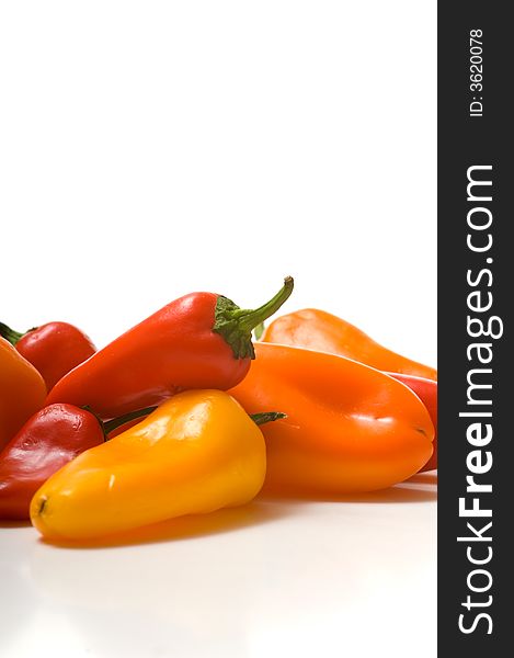 Fresh sweet peppers on white background, with copy space