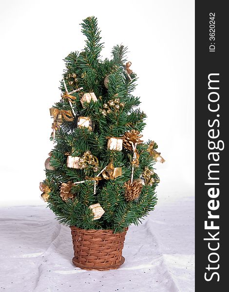 Miniature decorated Christmas tree in wicker basket. Miniature decorated Christmas tree in wicker basket
