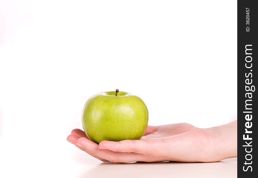 Woman holding a green apple in her hand. Woman holding a green apple in her hand