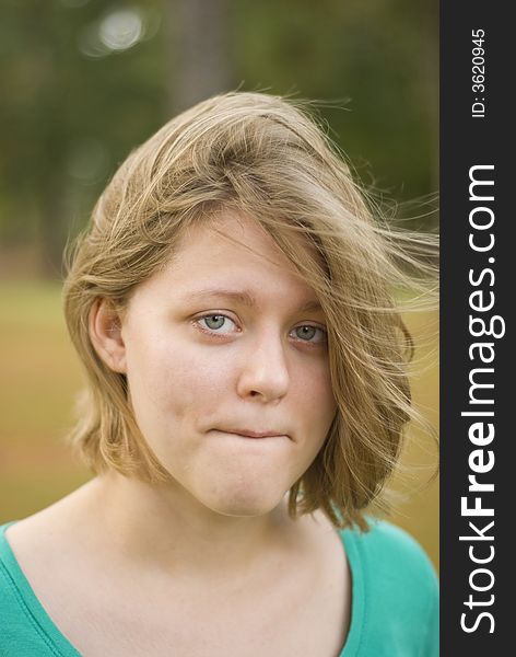 Portrait of a girl with the wind blowing through her hair. Focus is only centered around the eyes. Portrait of a girl with the wind blowing through her hair. Focus is only centered around the eyes