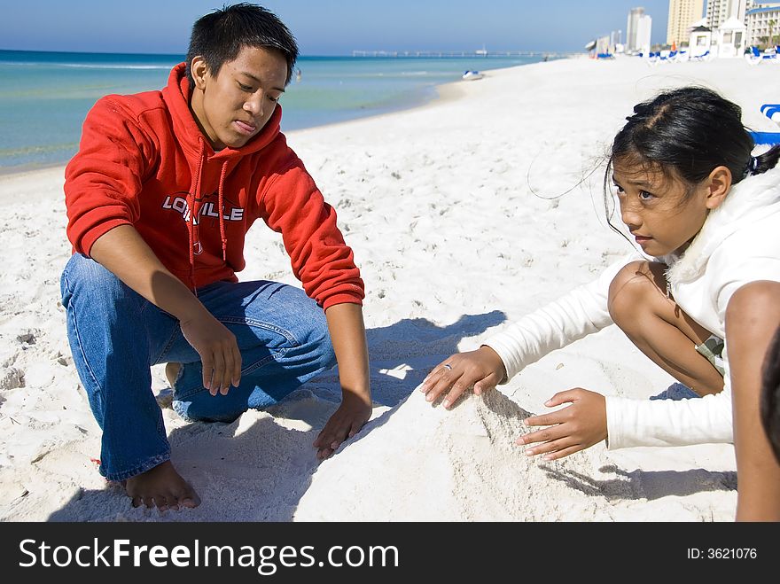 Kids Playing On The Beach