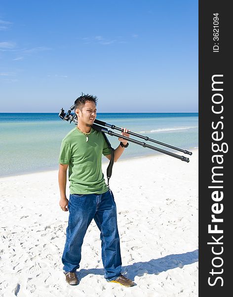 Picture of a photographer walking on the beach. Picture of a photographer walking on the beach