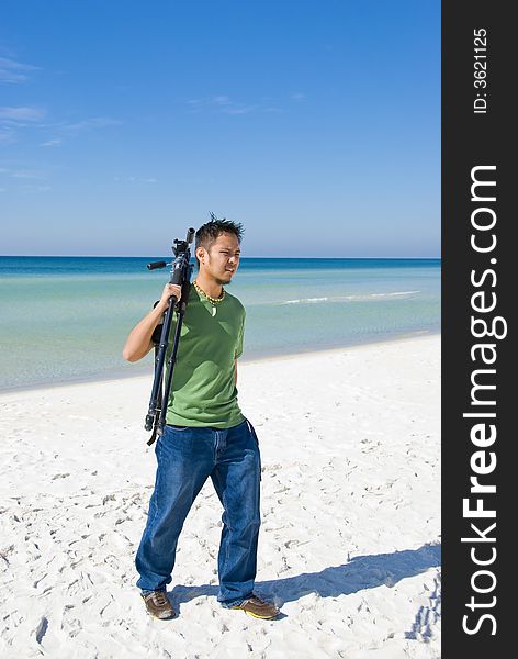 Picture of a photographer walking on the beach. Picture of a photographer walking on the beach