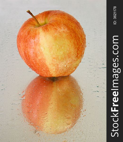 Red wet apple with reflections