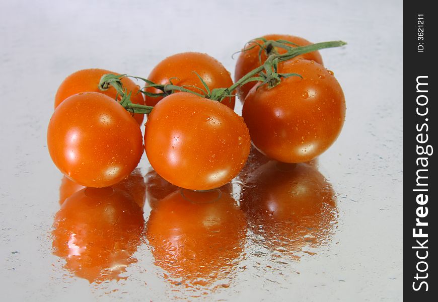 Vine tomatoes in a wet surface