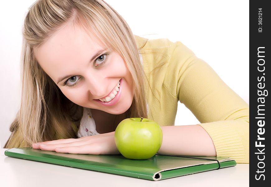 Smilling female student with green folder and apple