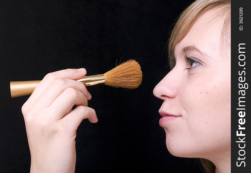 Portrait of smiling beautiful young woman with makeup brush. Portrait of smiling beautiful young woman with makeup brush