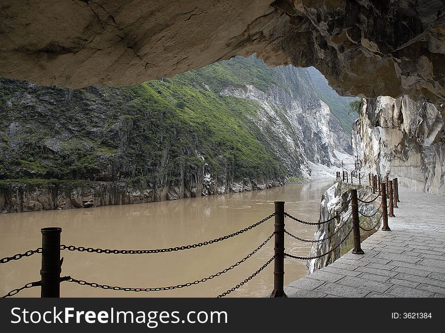 Plank road built along a cliff beside the river in Yunnan China