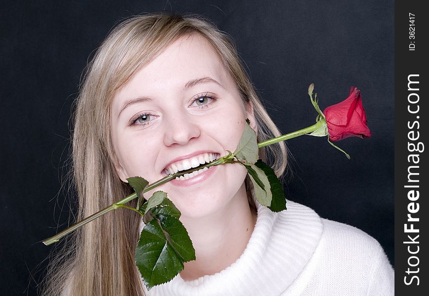 Young Women With Red Rose In The Mouth