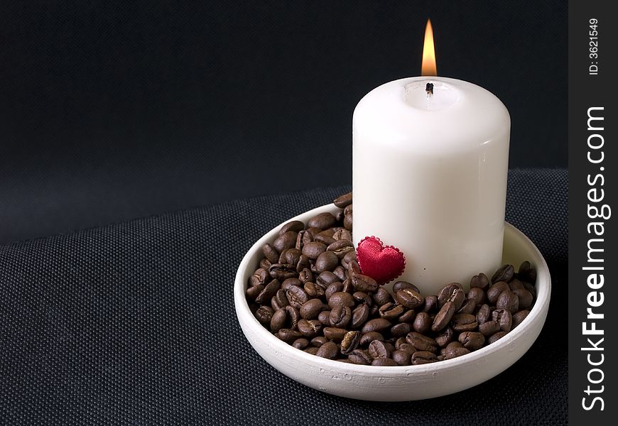 Candle, coffee beans and red hearts