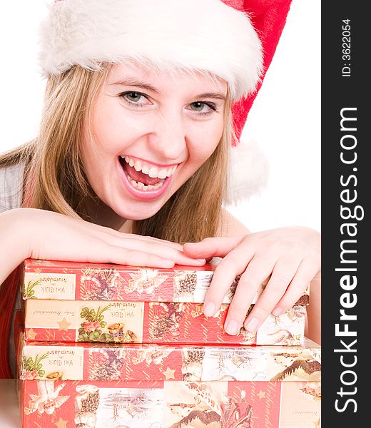 Smilling woman wearing a santa hat and holding christmas presents