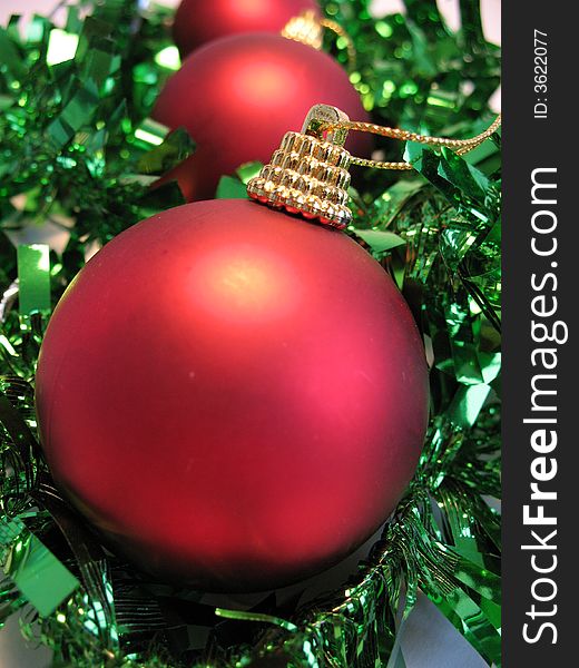 Red christmas ball on green glare background