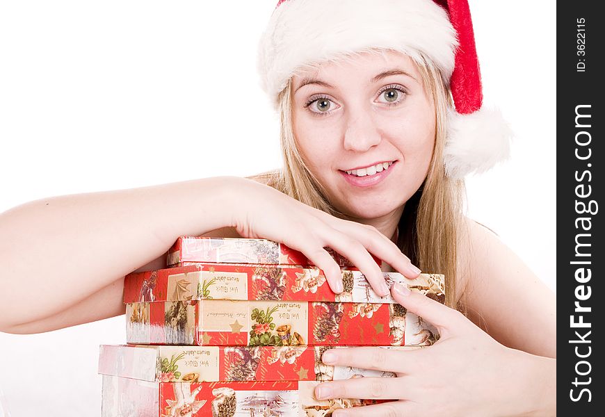 Girl In A Santa Hat And Christmas Presents.