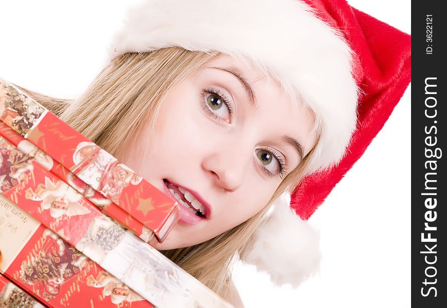 Girl In A Santa Hat And Christmas Presents.