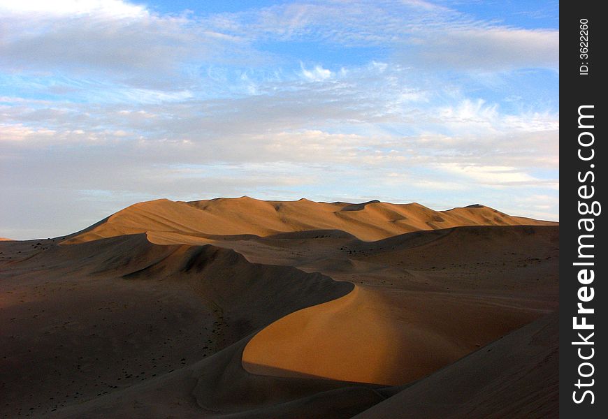 Wide desert has light side and shadow. Wide desert has light side and shadow