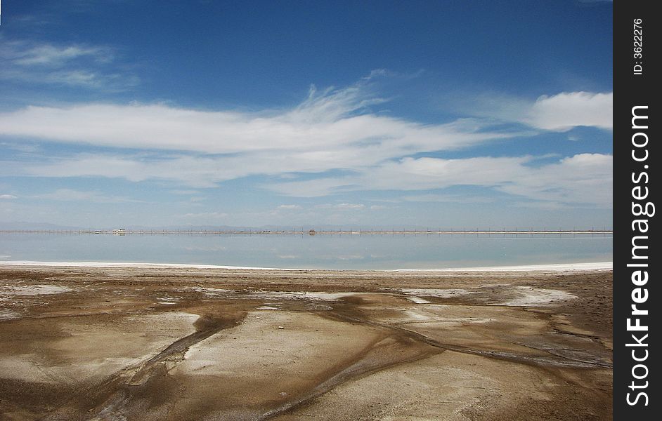 White salt lake under blue sky, fissured soil. White salt lake under blue sky, fissured soil
