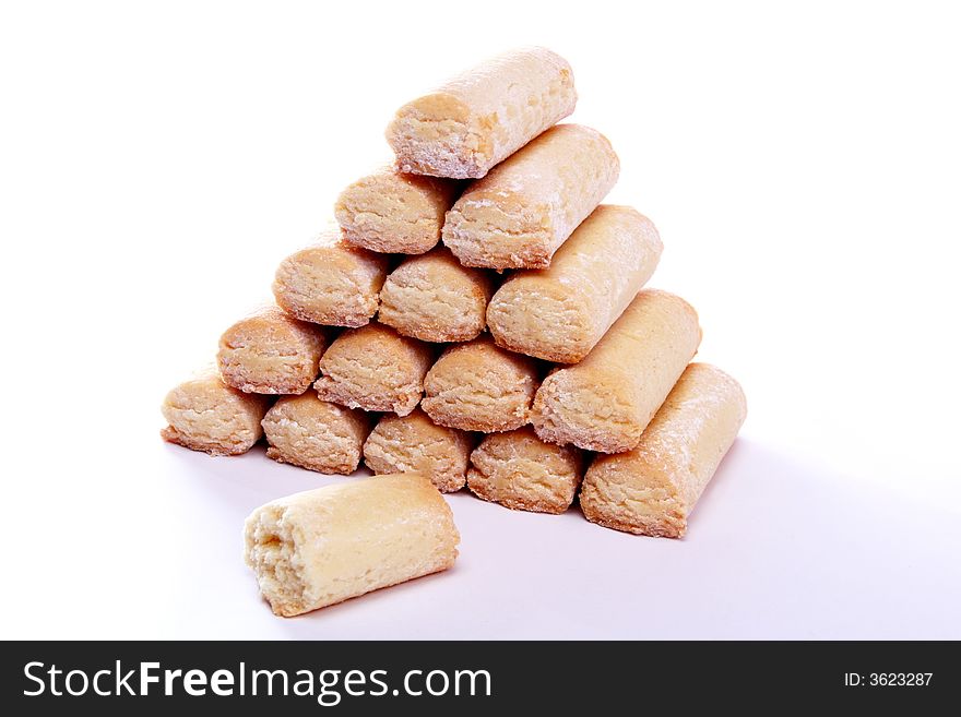 Pyramid made of fresh baked cookies with one bitten. Pyramid made of fresh baked cookies with one bitten