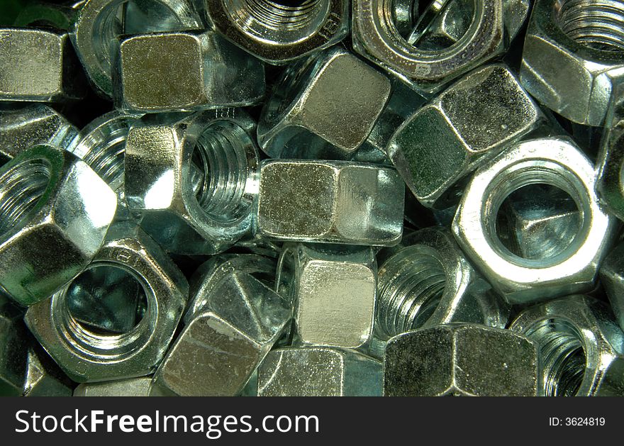 A pile of zinc plated hex nuts
