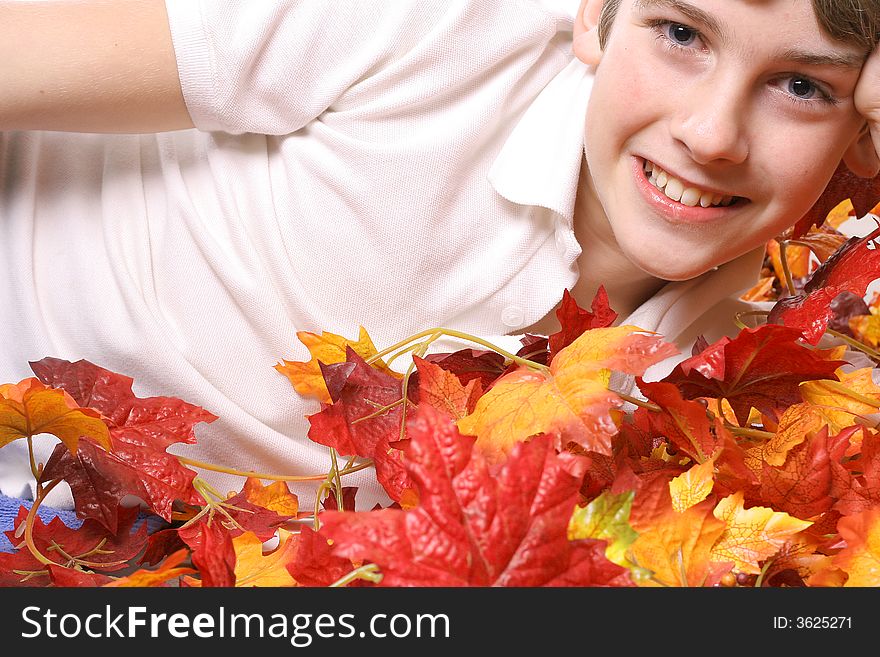 Shot of a young boy in Fall leaves