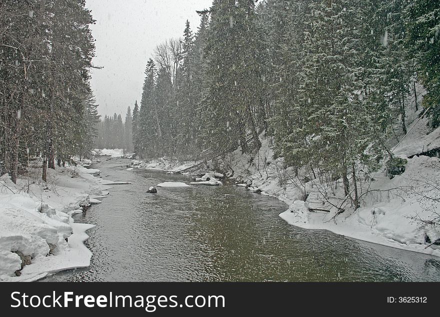 Snow falling on the Wenatchee River in Washington State, USA. Snow falling on the Wenatchee River in Washington State, USA