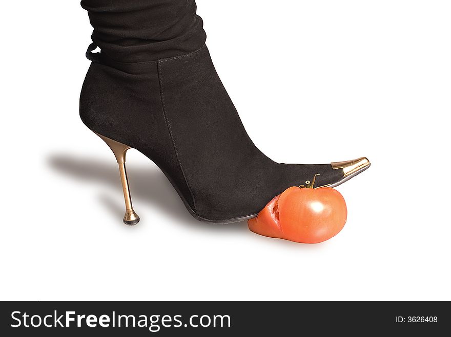 Black boots and tomato on a white background