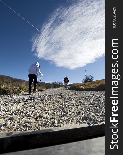 Couple hiking towards a transmitter antenna, Nanos - Slovenija. Couple hiking towards a transmitter antenna, Nanos - Slovenija.