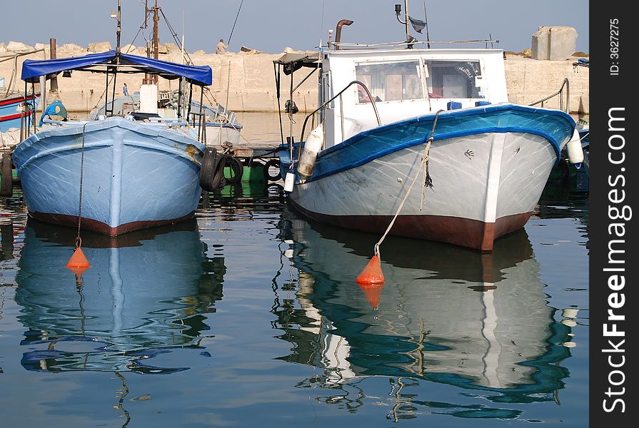 Solitary blue row boat in dock. Solitary blue row boat in dock