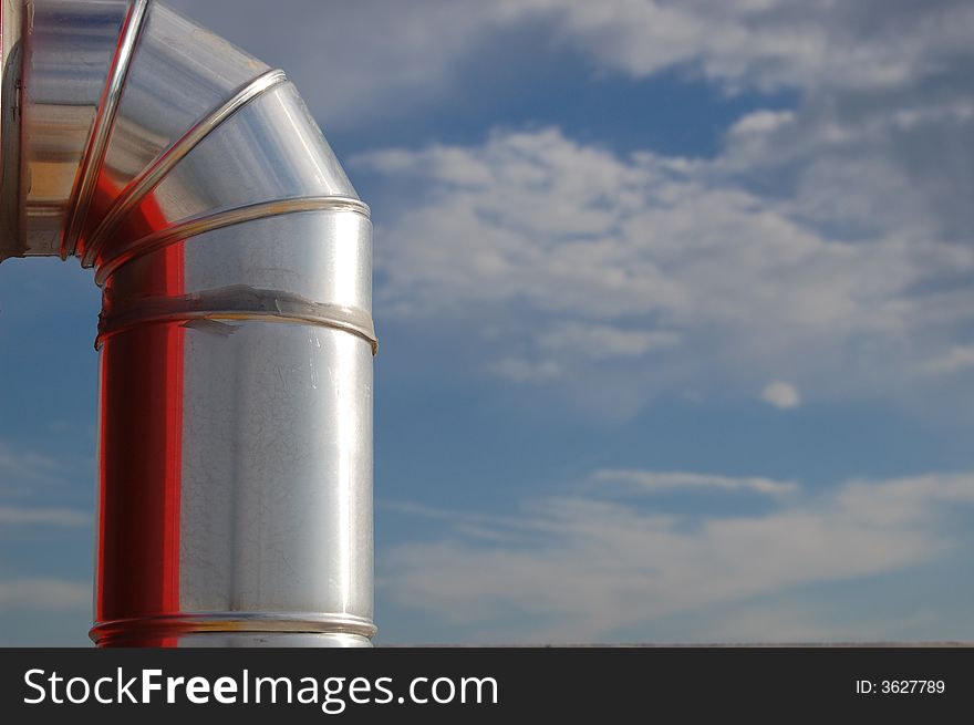 The metal tube of an hydrant reflecting its red box and the light from the sun