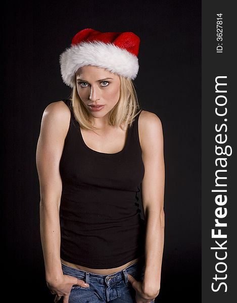 Coy attractive santa helper on a black background. Coy attractive santa helper on a black background