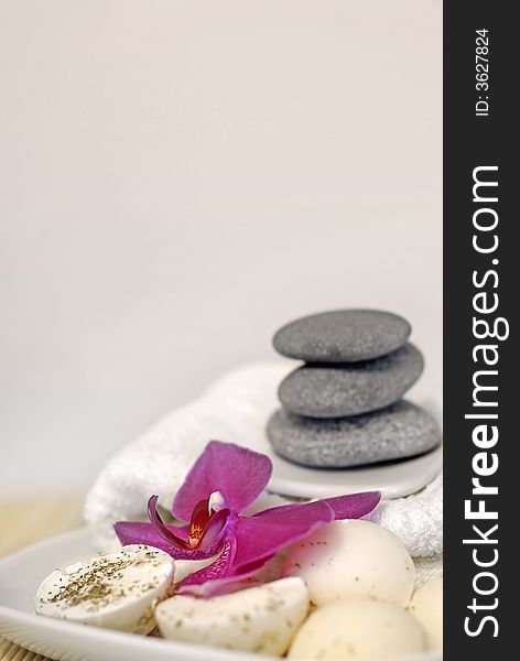 Natural oil soaps with orchid flower, pebble stones and white towel. Natural oil soaps with orchid flower, pebble stones and white towel