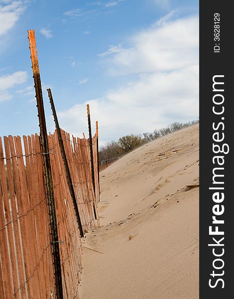 Cyclone fence installed on a beach to retain sand in winter. Cyclone fence installed on a beach to retain sand in winter
