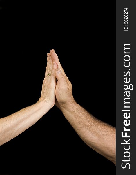 A man and woman's hands making a high five