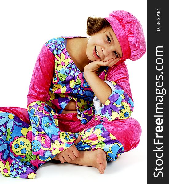 Portrait of a happy preteen girl sitting cross-legged in colorful hippie attire. Portrait of a happy preteen girl sitting cross-legged in colorful hippie attire.