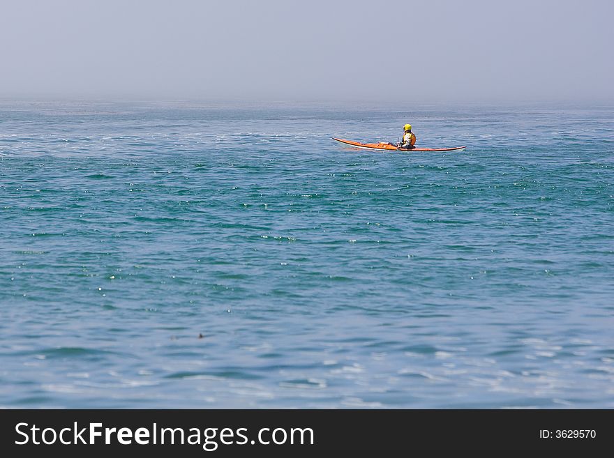 Kayaked on blue water with helmet. Kayaked on blue water with helmet