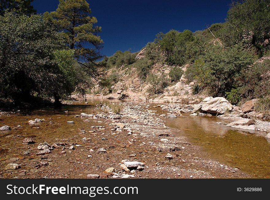 A clean shallow stream flows in Arizona during the wet season of late summer. A clean shallow stream flows in Arizona during the wet season of late summer.