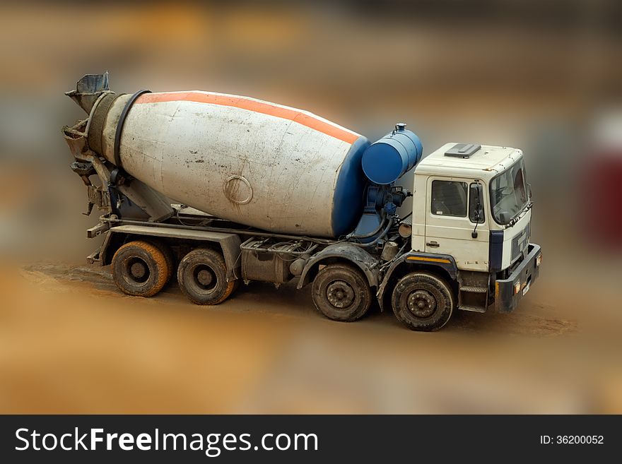 Concrete Mixer Truck on blurred background, close up. Concrete Mixer Truck on blurred background, close up.