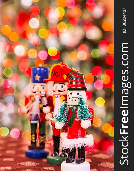 Three christmas figures on the tree background