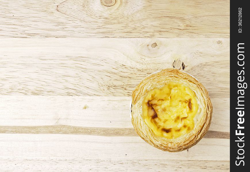 Piece of delicious eggtart decorate on wood background. Piece of delicious eggtart decorate on wood background